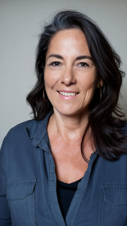 Smiling woman in denim shirt, approx. 40-45 years old
